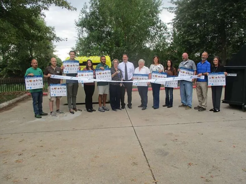 Siloam Springs Mayor Judy Nation cuts ribbon for multifamily recycling program at Spring Valley Apartments