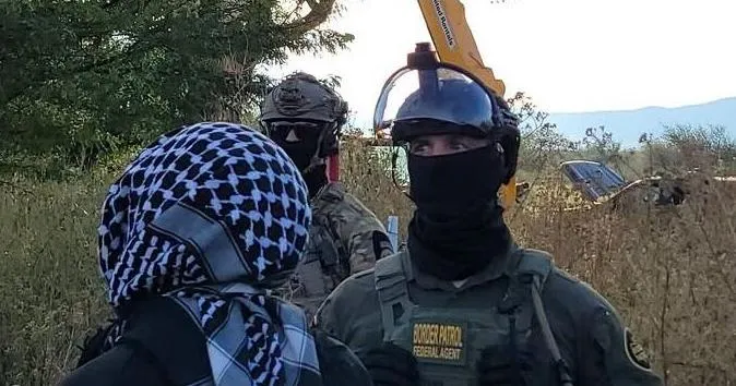 Border Patrol agents remove protesters, take down cottonwood tree