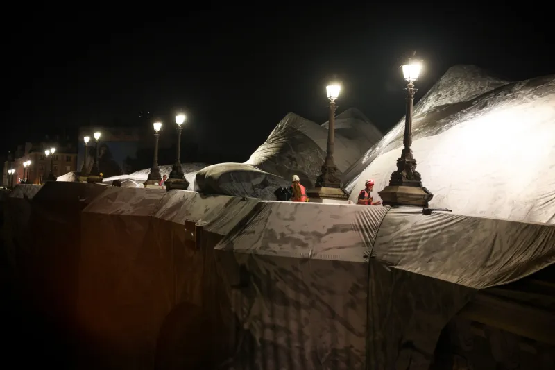 French artist JR begins his giant 'cave' art inflation over Paris' oldest bridge