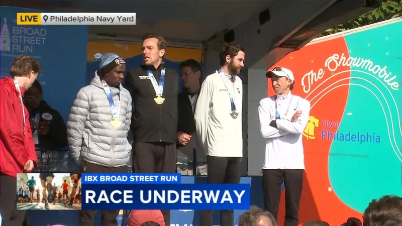 Runners cross the finish line of the IBX Broad Street Run