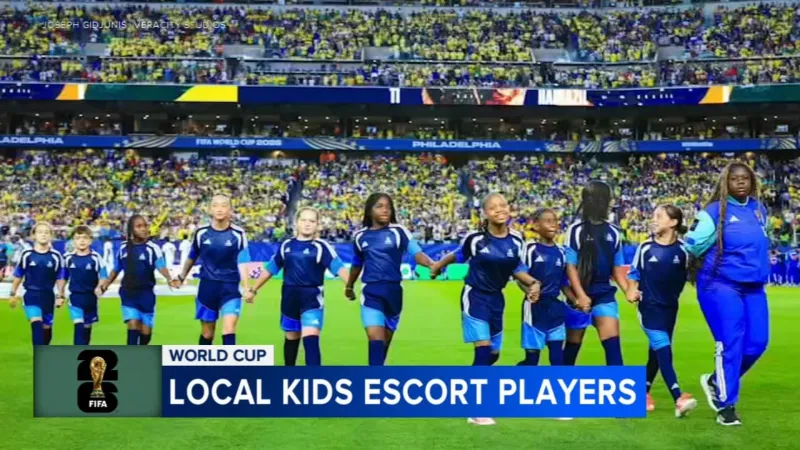 Young local athletes walk players onto field at Brazil-Haiti match