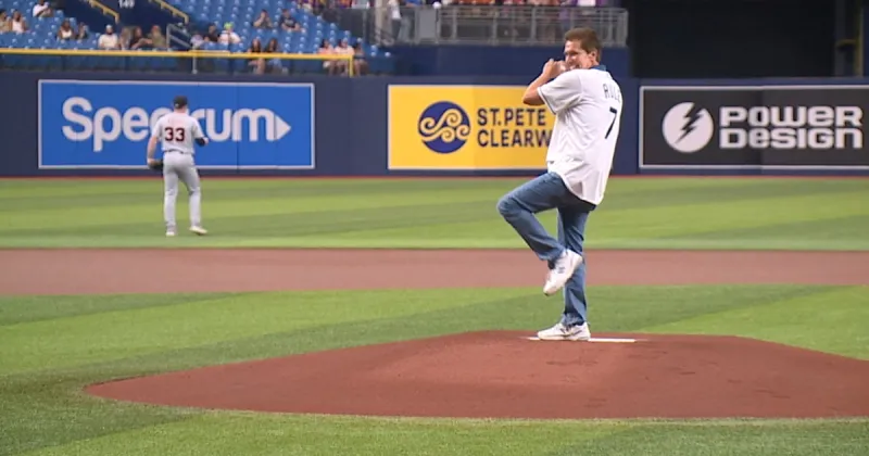 Tampa Bay 28 Chief Meteorologist Denis Philips throws out the first pitch at the Rays game