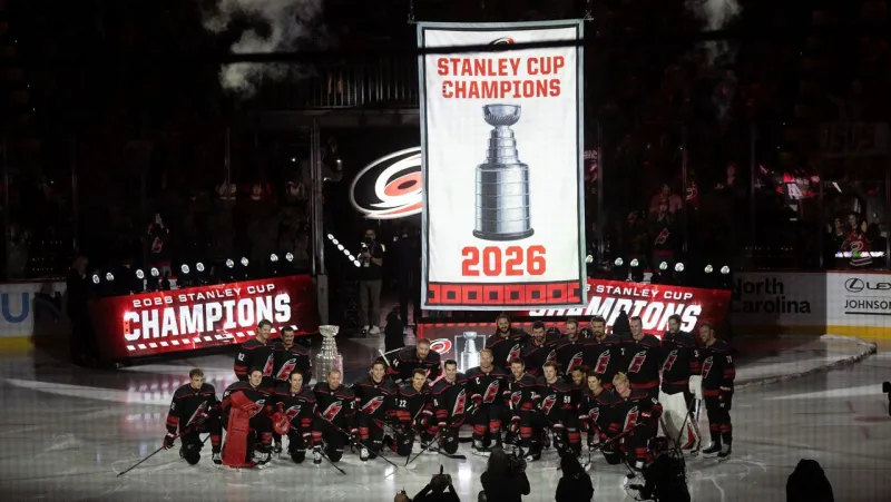Hurricanes raise banner, lose opener to Panthers in OT