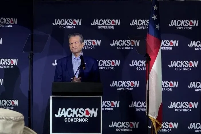Lt. Gov. Burt Jones debates an empty podium as Rick Jackson campaigns in Kennesaw