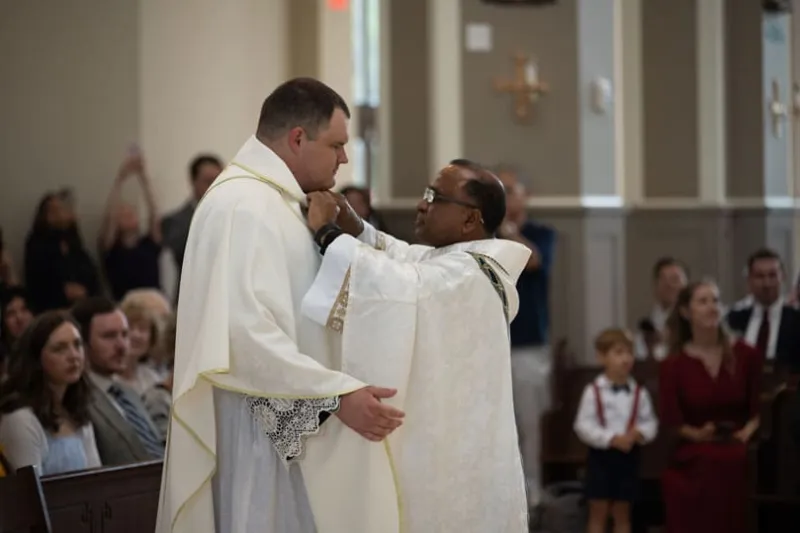 Vesting priests walk with the newly ordained as mentors, friends