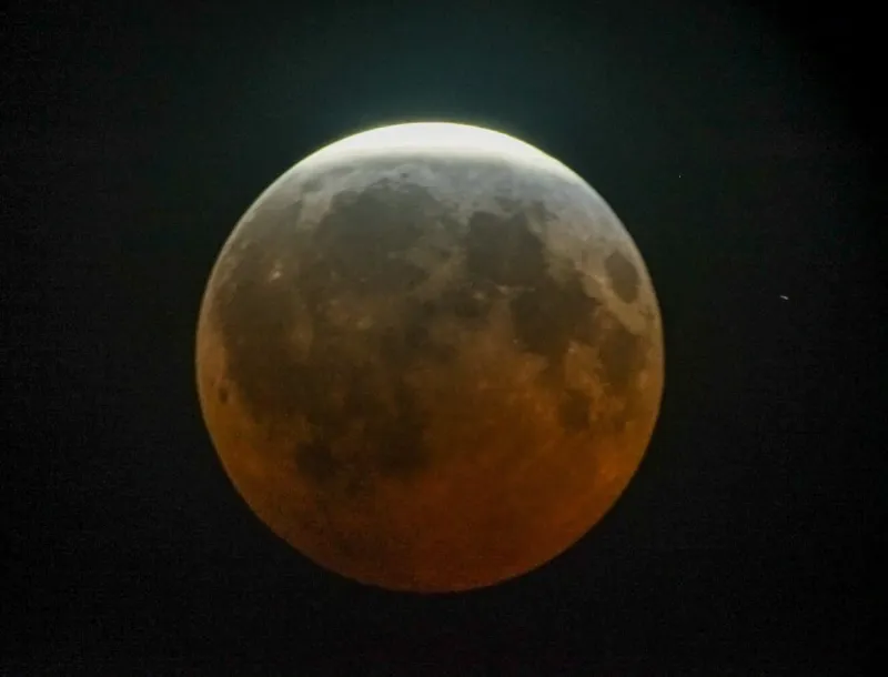 Near-total lunar eclipse dazzles skywatchers across the Americas and Europe