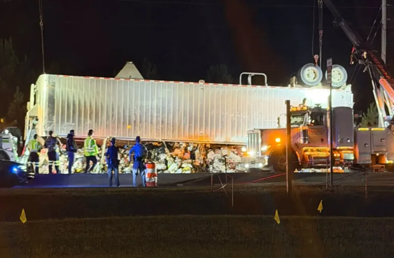 Overturned 18-wheeler spills 60,000 pounds of garbage on Candler Road