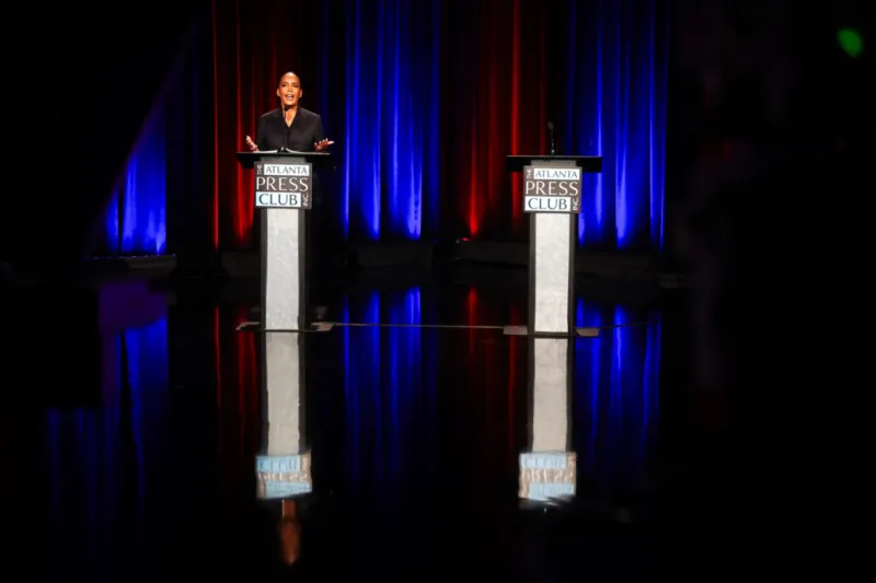 Bottoms faces empty podium on debate stage while Jackson campaigns with Kemp