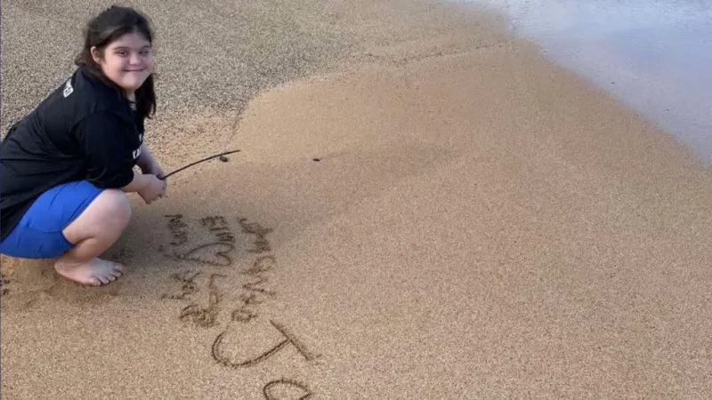 Teen on Kauai with Down Syndrome turns beach sand messages into business