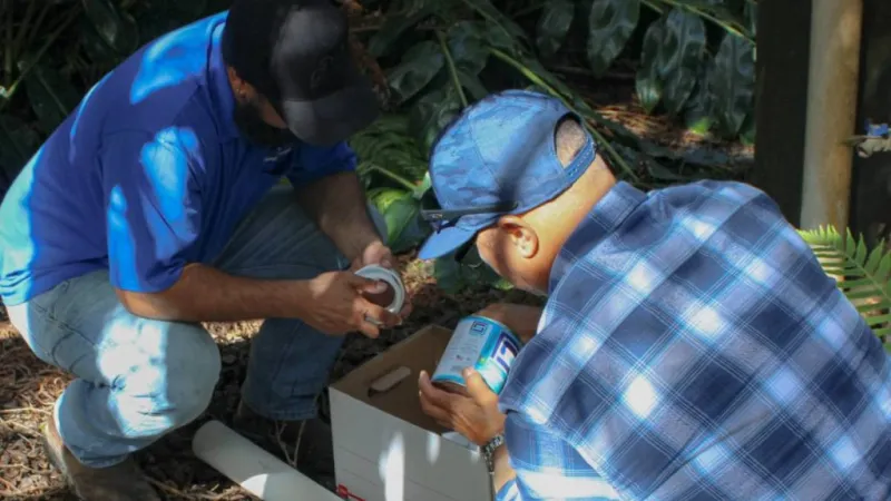 Volunteer plumbers travel to Volcano Village to install catchment diverters at 30 homes