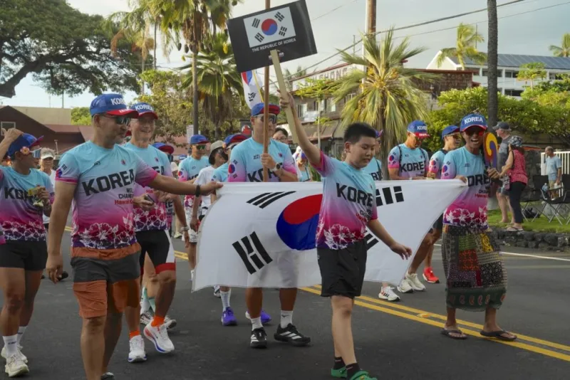 Triathletes flood Ali'i Drive for Ironman's Parade of Nations