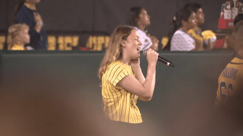 University of Iowa student performs National Anthem at Banana Ball game in Kinnick Stadium