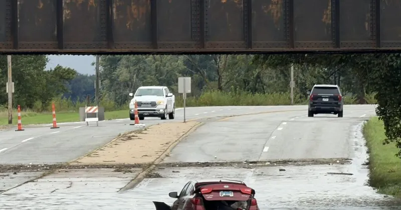 Heavy rains leave a car in flood waters on West River Drive in Davenport on Sunday