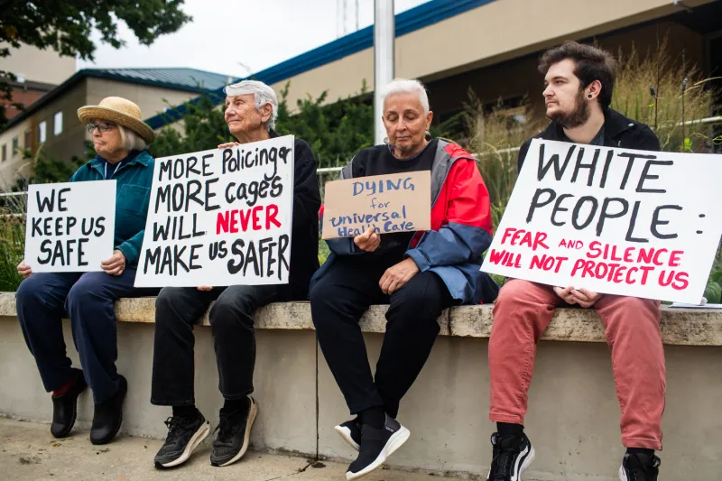 Residents protest police staff additions outside City Hall