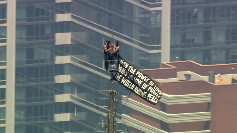 WATCH LIVE: Two people scale to top of Empire State Building carrying banner