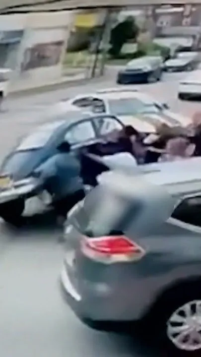 Strangers lift car off woman trapped after e-bike crash (Video)