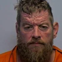 Man accused of hunting down, battering woman who fled him to live in a tent