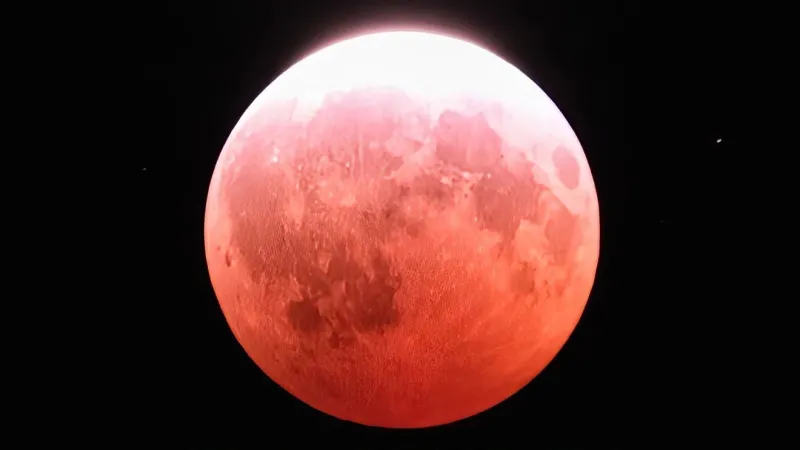 Partial lunar eclipse bathe moon in red hues