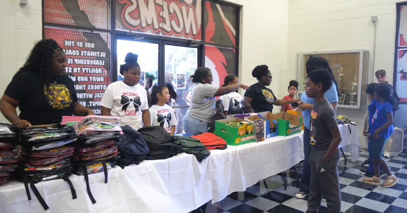 Omarion Miller, Mikaylah Williams hold backpack giveaways