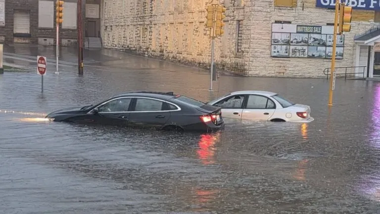 Heavy rains flood some South Coast roads, trapping cars