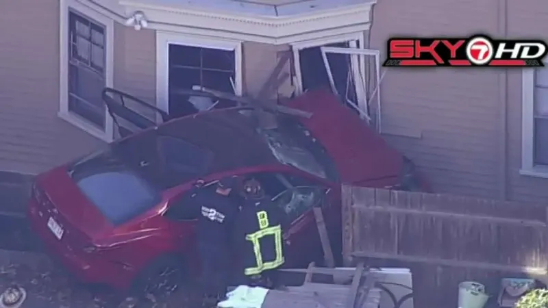 Crews respond after car crashes into building in Jamaica Plain