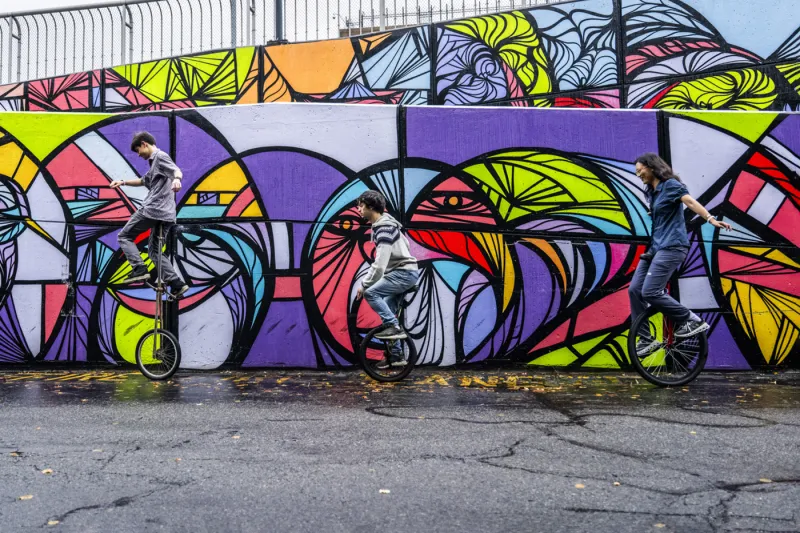 Northeastern students bond by riding unicycles around campus
