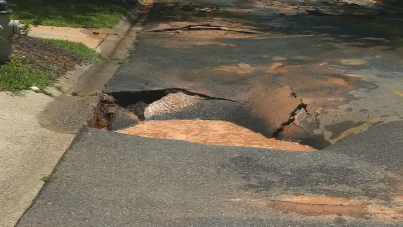 Road buckles after water main break in Bethesda