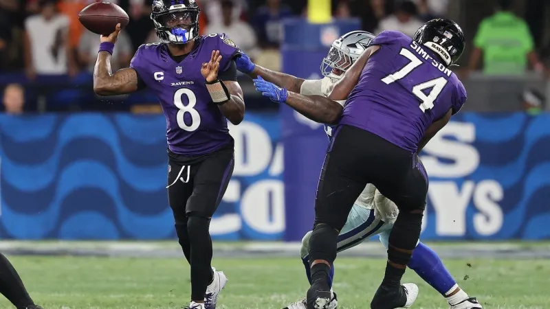 Ravens quarterback Lamar Jackson (back) participating at the start of practice on Thursday