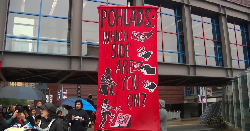Protesters rally outside Target Field to push Pohlad family to "stand up for democracy"