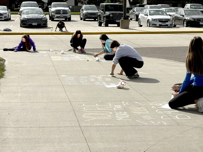 Chalk art communicates positive slogans, coping skills