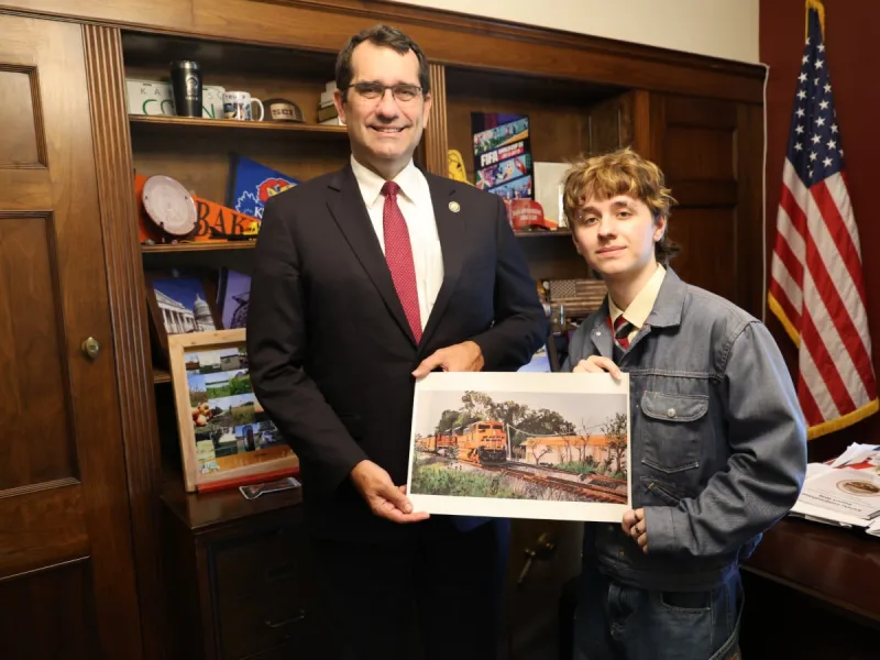 Rep. Derek Schmidt congratulates Congressional Art Competition winner Leo Norman