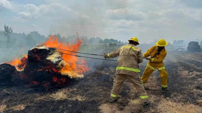 Firefighters battle hay baler, field fire in Shelby County