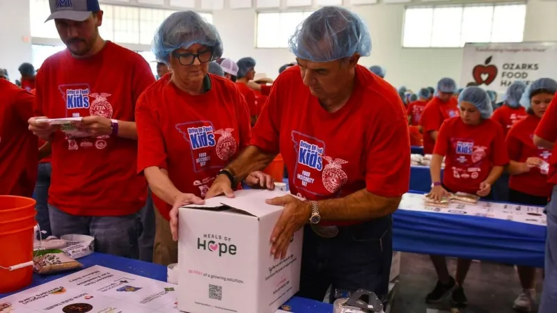 Governor Kehoe and First Lady join FFA members packing meals at state fair