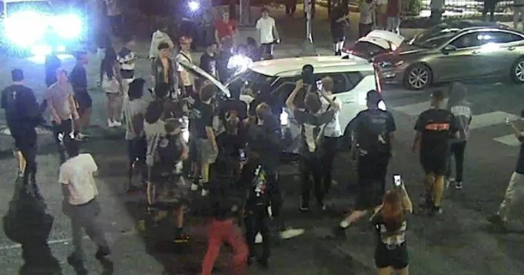 Woman, 19, charged in Bevo area street takeover; police seek 3 others