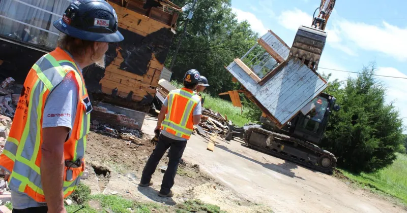 Team Rubicon volunteers work to demolish tornado-damaged homes