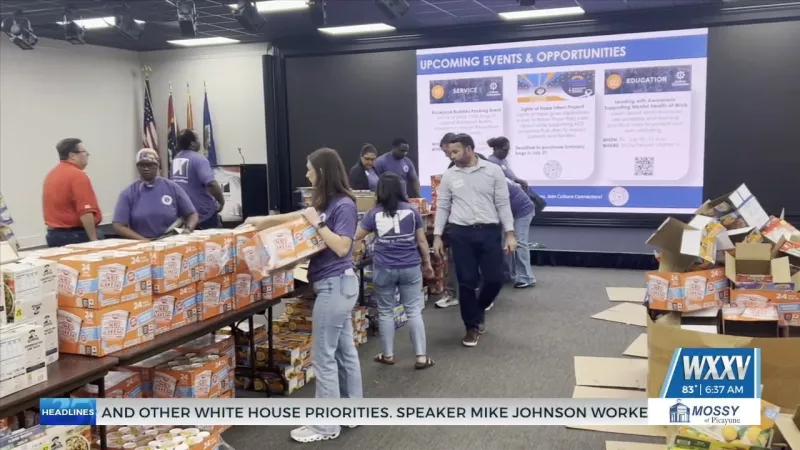 Ingalls Shipbuilding employees pack Backpack Buddy food bags for Jackson County Students