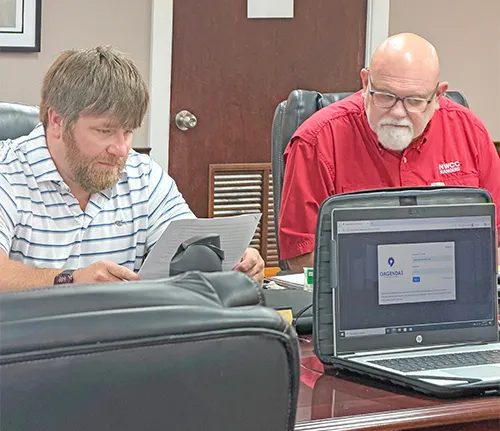 Superintendent informs school board of test scores, audit, recognition of employees