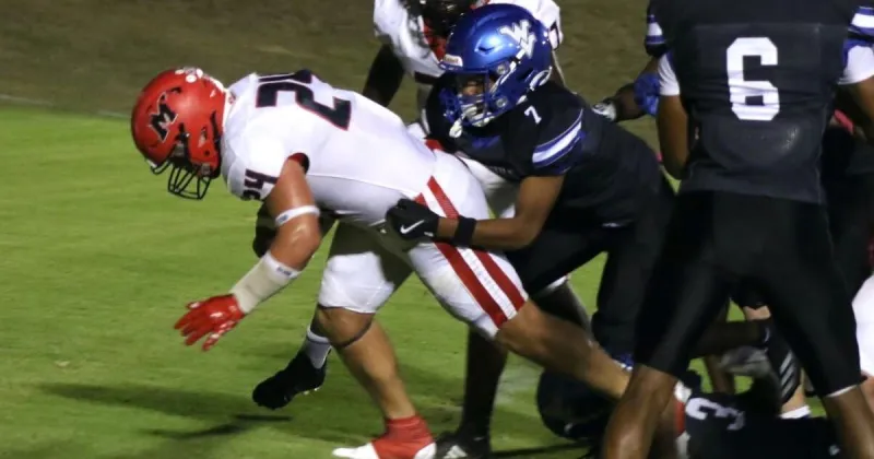 Freshman quarterback Jake Murphy helps Myrtle roll past Walnut