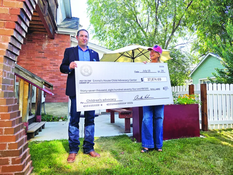 Knudsen tours Emma's House, presents award