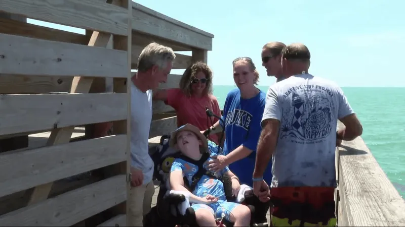 11-year-old catches first wave with help from ENC adaptive surfing program