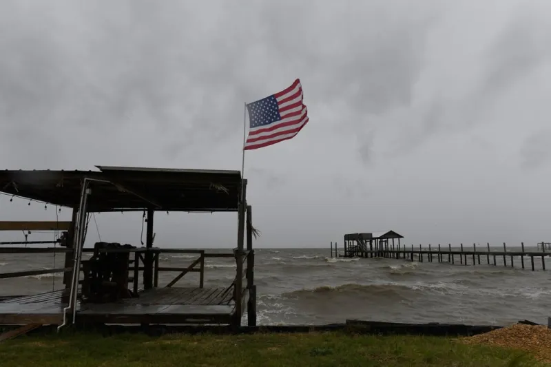 Isaias weakens but flooding threat persists as hundreds of thousands grapple with power outages