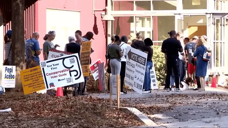 Buncombe County voters take election debates door-to-door ahead of Trump rally