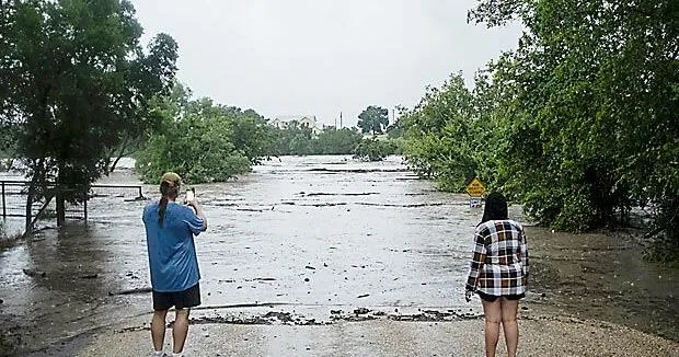 Texas flooding surges from huge rainstorms as rescuers pull people from rising waters