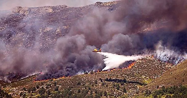 Thousands of people flee raging wildfires in France, Spain, some escaping by boat