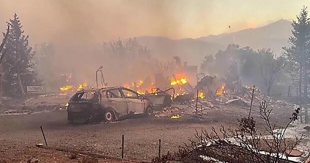 Firefighters progress against a Nevada wildfire that's destroyed more than 30 homes