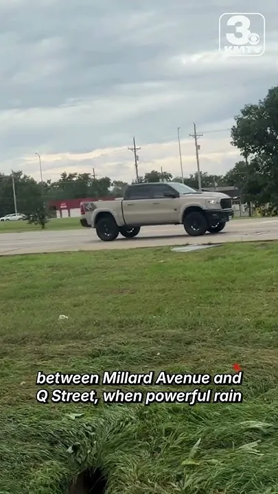 Car swept into drainage ditch during heavy rains in Omaha (Video)