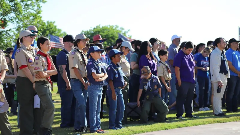 Volunteers place flags at Fort Bliss National Cemetery for Memorial Day
