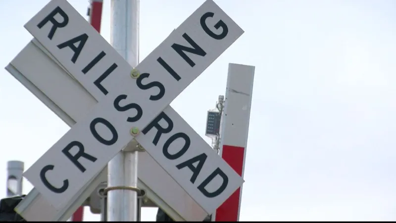 Crossing arm assembly collapsed onto 12th Street after grain cart strike, no injuries