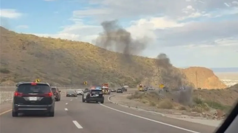 Single-vehicle rollover on Transmountain; dark smoke seen down the mountain