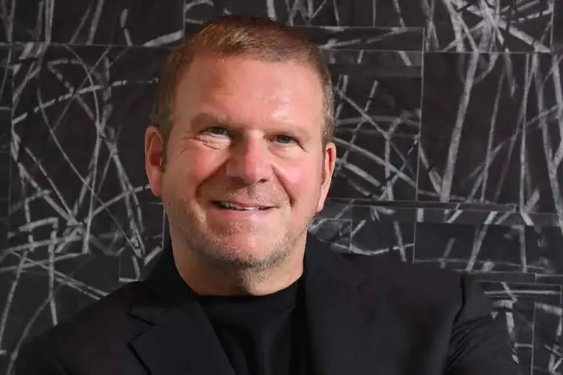 Who is Tilman Fertitta, the billionaire acquiring Caesars Entertainment?